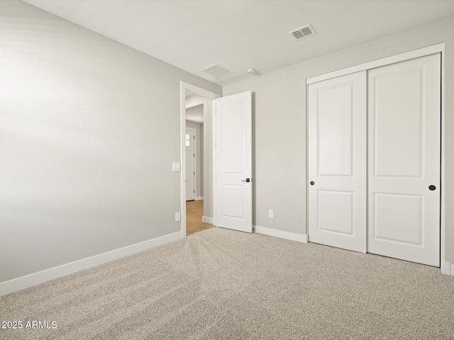 unfurnished bedroom with carpet floors and a closet