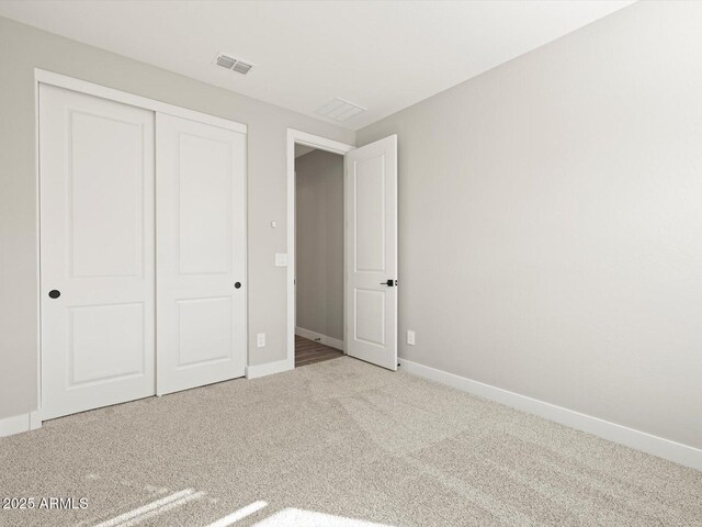 unfurnished bedroom with a closet and carpet