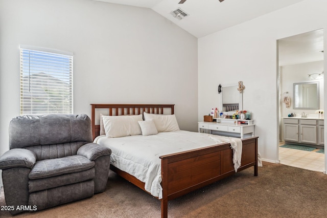 carpeted bedroom with ceiling fan, lofted ceiling, and connected bathroom