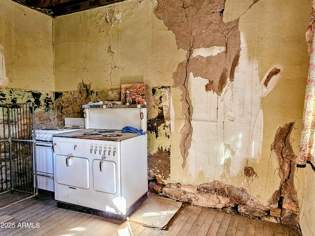 83 Ok St, Bisbee, AZ 85603 - kitchen with electric range, hardwood / wood-style flooring, and washing machine and dryer