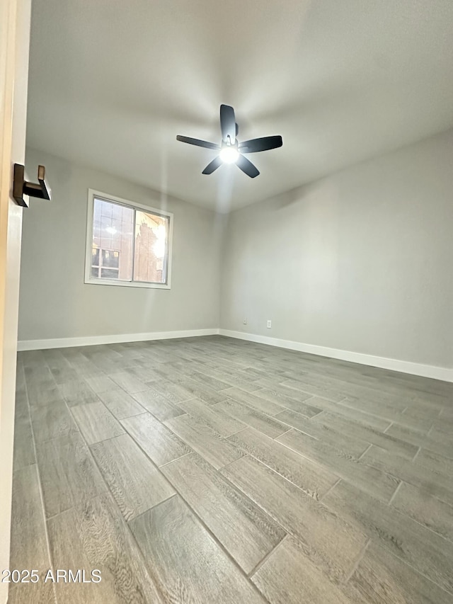 4902 S Fair Ln, Tempe, AZ 85282 - unfurnished room featuring wood finished floors, a ceiling fan, and baseboards