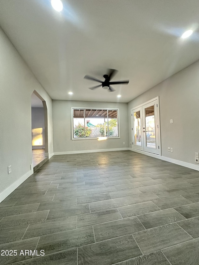 4902 S Fair Ln, Tempe, AZ 85282 - empty room featuring a ceiling fan, arched walkways, wood finish floors, baseboards, and recessed lighting