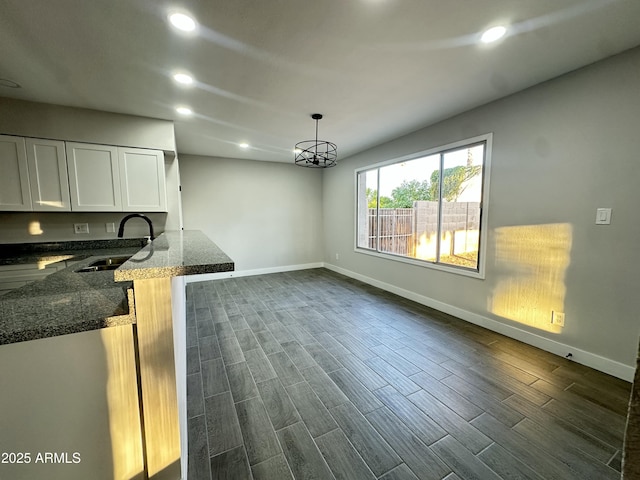 4902 S Fair Ln, Tempe, AZ 85282 - unfurnished dining area with a sink, baseboards, recessed lighting, dark wood-style floors, and a chandelier