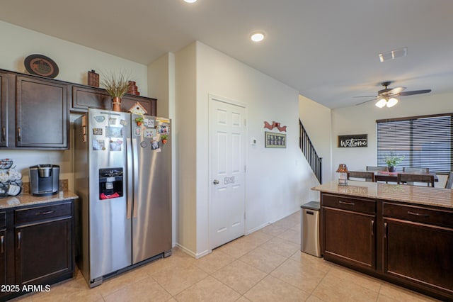 kitchen with ceiling fan, stainless steel fridge with ice dispenser, dark brown cabinets, and light stone counters