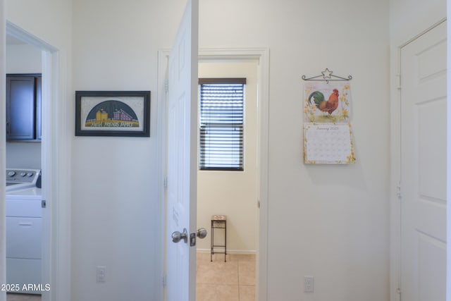 corridor with washer / dryer and light tile patterned flooring