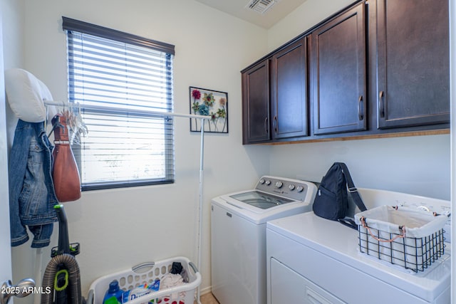 washroom with cabinets and washing machine and dryer