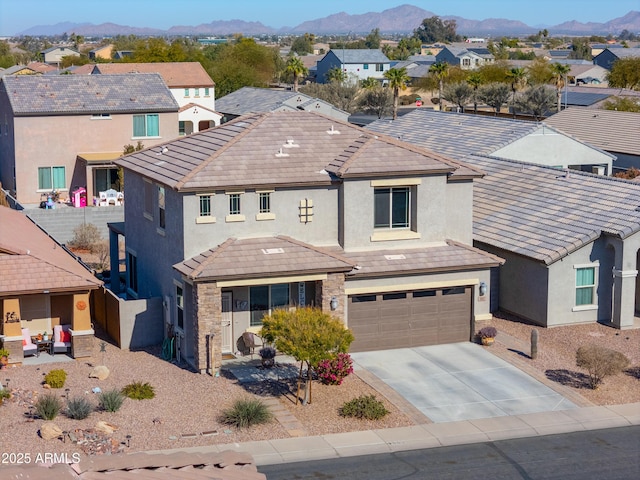 view of front of property with a mountain view and a garage