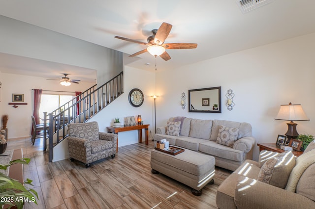 living room with ceiling fan and hardwood / wood-style flooring