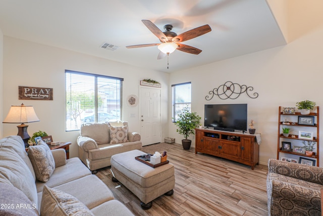 living room featuring ceiling fan and light hardwood / wood-style flooring