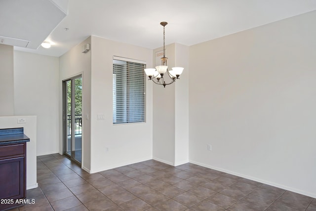 280 S Evergreen Rd Unit 1296, Tempe, AZ 85288 - unfurnished dining area featuring a chandelier and dark tile patterned flooring