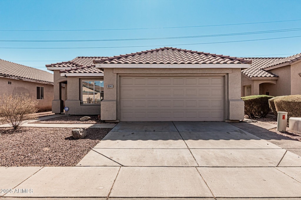 mediterranean / spanish-style house featuring a garage