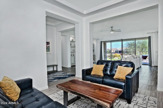 living room with light wood-type flooring and ceiling fan