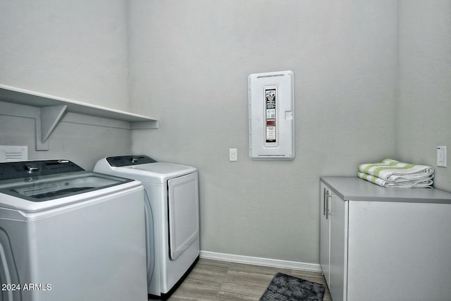 clothes washing area featuring washer and dryer and hardwood / wood-style floors