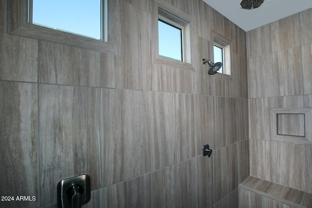 bathroom with tiled shower