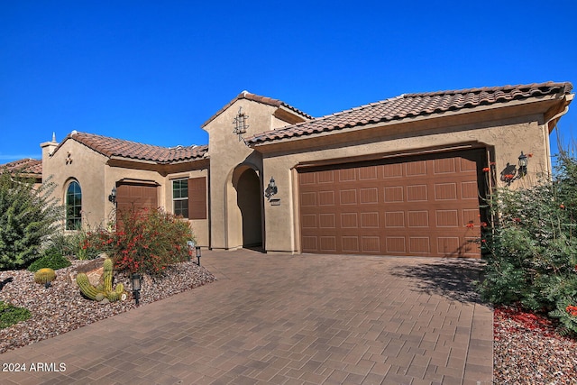 mediterranean / spanish-style home featuring a garage