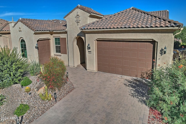 mediterranean / spanish-style home with a garage