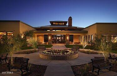 back house at dusk with a patio area