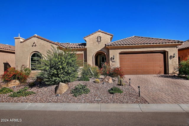 mediterranean / spanish-style home with a garage