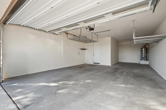 22341 N 100th Ln, Peoria, AZ 85383 - garage featuring strapped water heater, a garage door opener, and baseboards