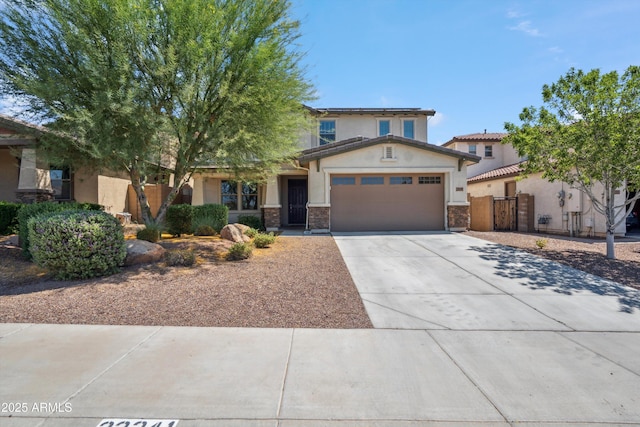 22341 N 100th Ln, Peoria, AZ 85383 - view of front of home with a garage, stucco siding, driveway, stone siding, and a gate