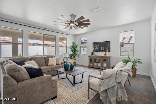 22341 N 100th Ln, Peoria, AZ 85383 - living area featuring a ceiling fan, baseboards, and light carpet