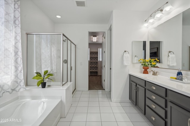 22341 N 100th Ln, Peoria, AZ 85383 - bathroom featuring vanity, a garden tub, a stall shower, tile patterned floors, and baseboards
