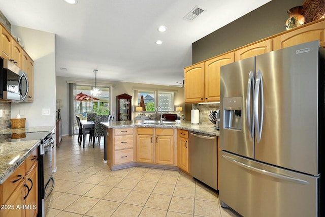 kitchen with visible vents, appliances with stainless steel finishes, light tile patterned flooring, a sink, and a peninsula