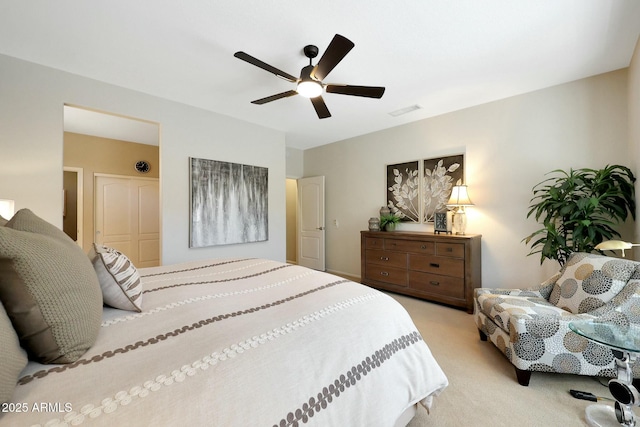 carpeted bedroom featuring visible vents and ceiling fan