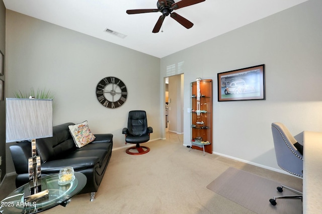 carpeted home office with a ceiling fan, visible vents, and baseboards