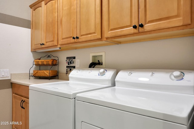 laundry room featuring washer and clothes dryer and cabinet space