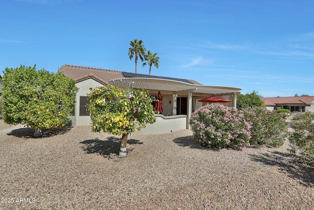 view of front of home with a pergola and stucco siding