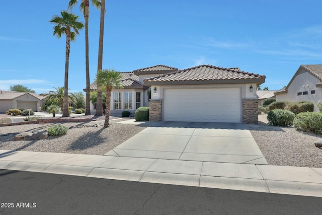 view of front of home with a garage, concrete driveway, stone siding, a tiled roof, and stucco siding