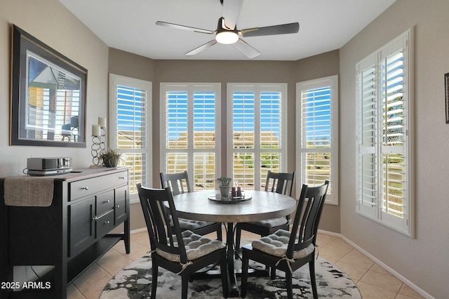 dining room featuring ceiling fan, baseboards, and light tile patterned floors