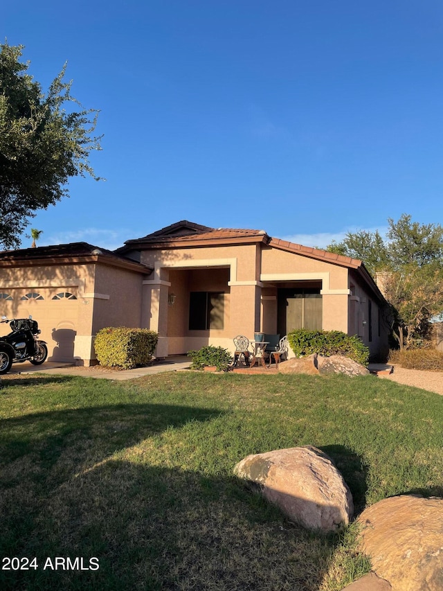 prairie-style house with a front lawn and a garage