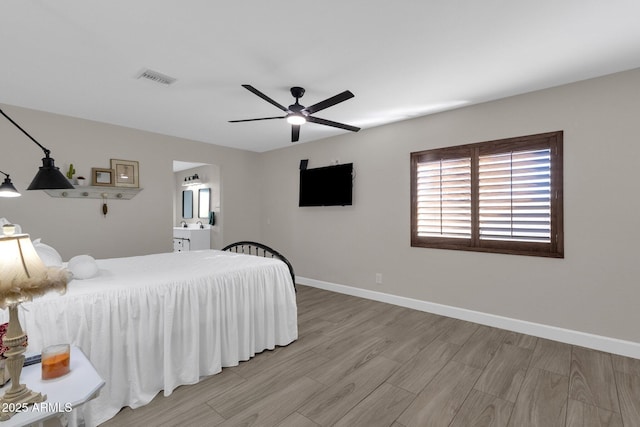 bedroom featuring ensuite bathroom, ceiling fan, and light hardwood / wood-style floors