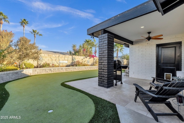 view of patio featuring ceiling fan