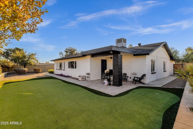 rear view of property with central air condition unit, a patio area, and ceiling fan