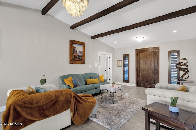 living room with a chandelier, vaulted ceiling with beams, and light hardwood / wood-style flooring