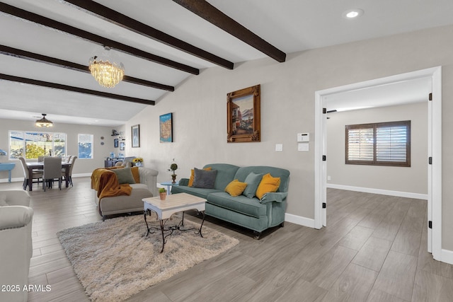 living room featuring an inviting chandelier and vaulted ceiling with beams