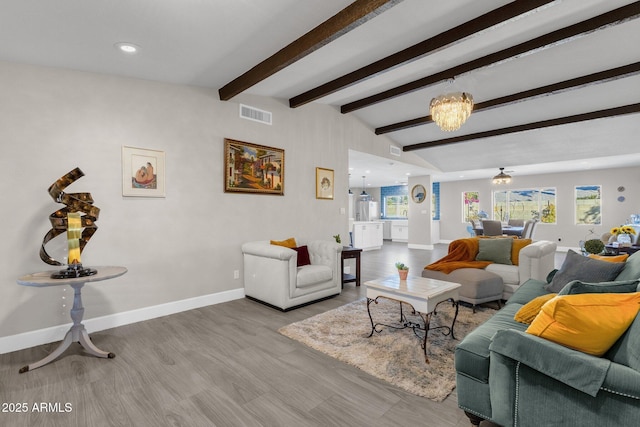 living room with wood-type flooring, a notable chandelier, and beam ceiling