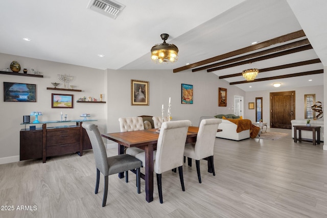 dining space with beamed ceiling, light hardwood / wood-style floors, and a notable chandelier