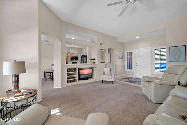 living room featuring ceiling fan and light colored carpet