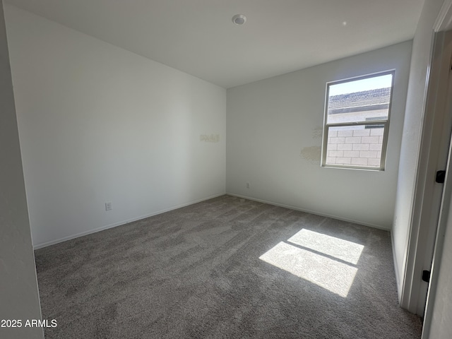 empty room with carpet floors and baseboards