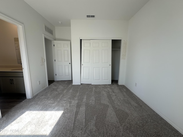 unfurnished bedroom featuring a closet, visible vents, and carpet floors