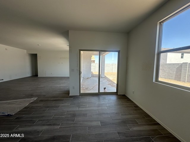 empty room with dark wood-type flooring