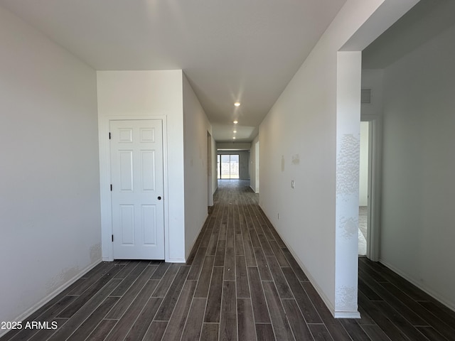 corridor featuring recessed lighting, dark wood-style floors, and baseboards