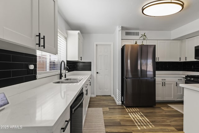 kitchen with white cabinetry, dark hardwood / wood-style flooring, sink, and black appliances