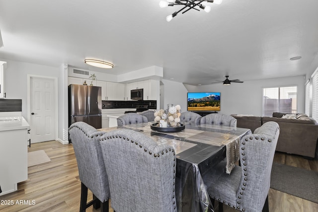 dining area featuring ceiling fan and light hardwood / wood-style flooring