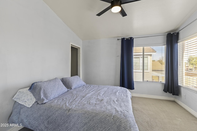 carpeted bedroom with ceiling fan and lofted ceiling