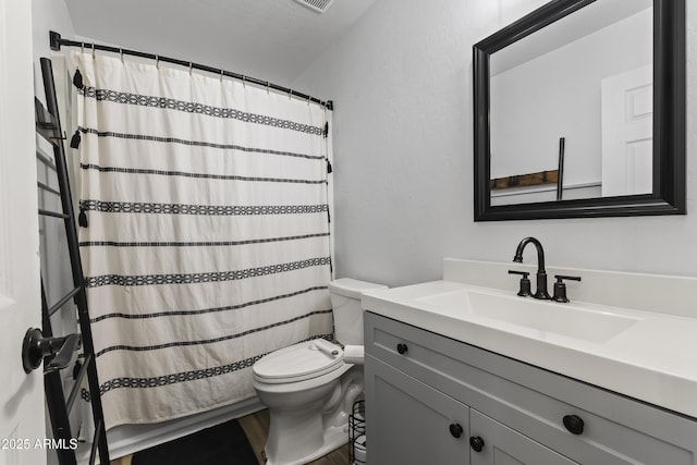 bathroom with vanity, walk in shower, and toilet